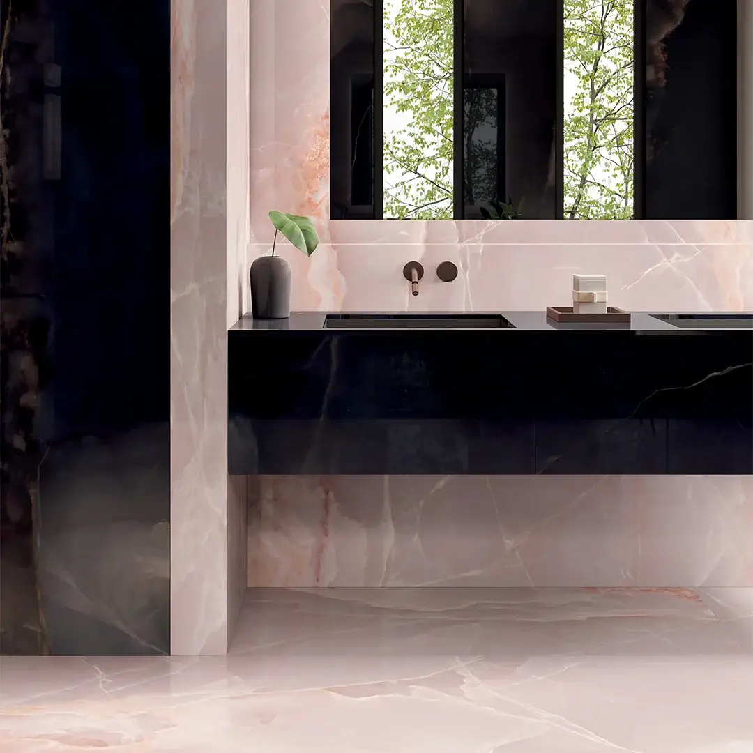 Bagno: lavandino nero, piano in marmo, pianta, grandi finestre, verde.