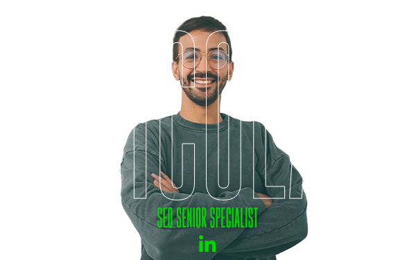 Smiling bearded man with glasses, arms crossed, "NICOLA, SEO Senior Specialist" and LinkedIn icon below.