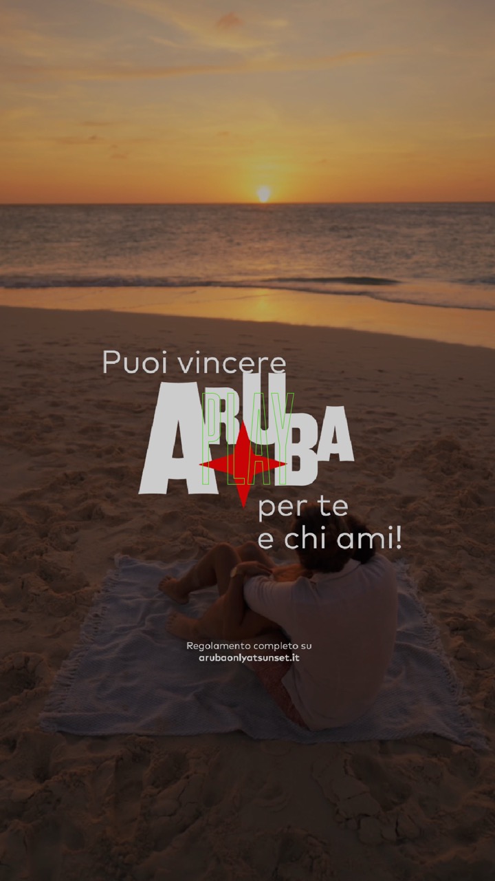Una persona su un telo in spiaggia al tramonto, testo: Vinci Aruba.